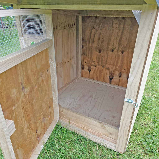 Inside view of compact duck house with doorstop to stop wood shavings falling out.