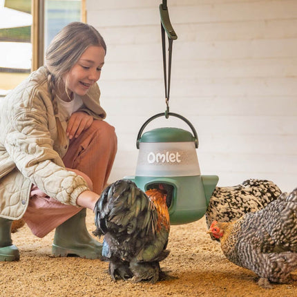 2.5kg no waste chicken feeder by Omlet hangs on the optional adjustable feeder and drinker hanger